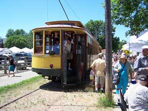 Here passengers are shown unloading from the uniquely designed open rear platform that was protected by wire gates controlled from the front of the car by the Motorman.