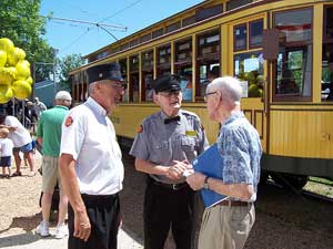 Bruce Kobs (left) and Excelsior Streetcar Line Superintendent, Bob Johnson (center) chat with a visitor.