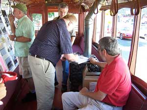 Shown signing a copy of the book is John Diers while the other author, Aaron Isaacs waits his turn.