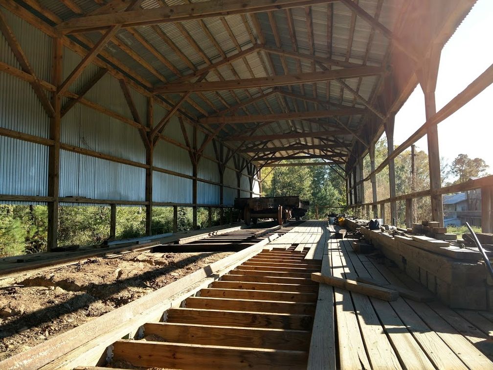 new track under the log car in the shop.jpg
