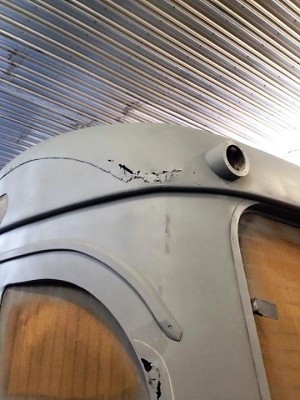 26 left side showing corrosion after 9 coats of old paint were removed.jpg