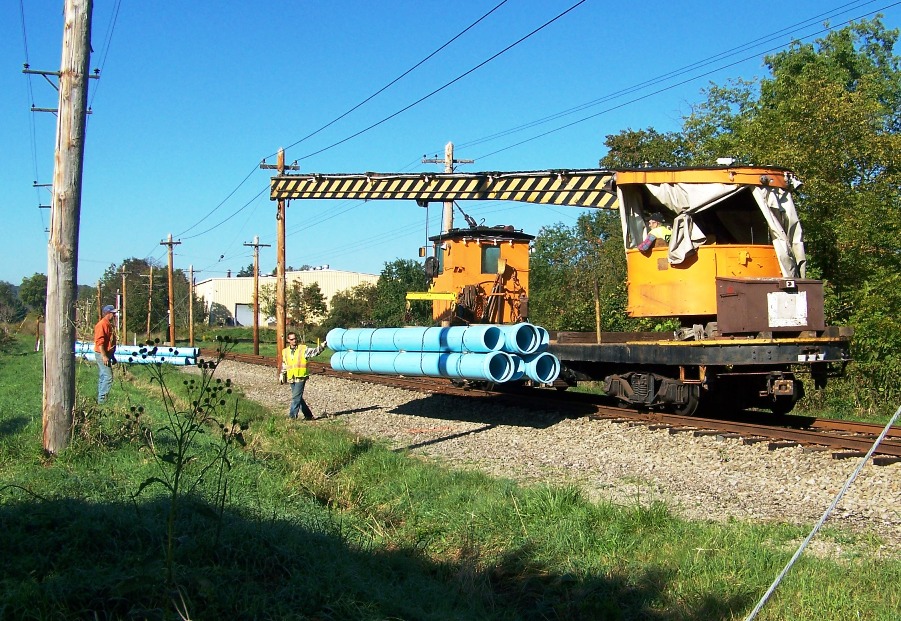 Crane Car - unloading sewer pipe-c-40.jpg